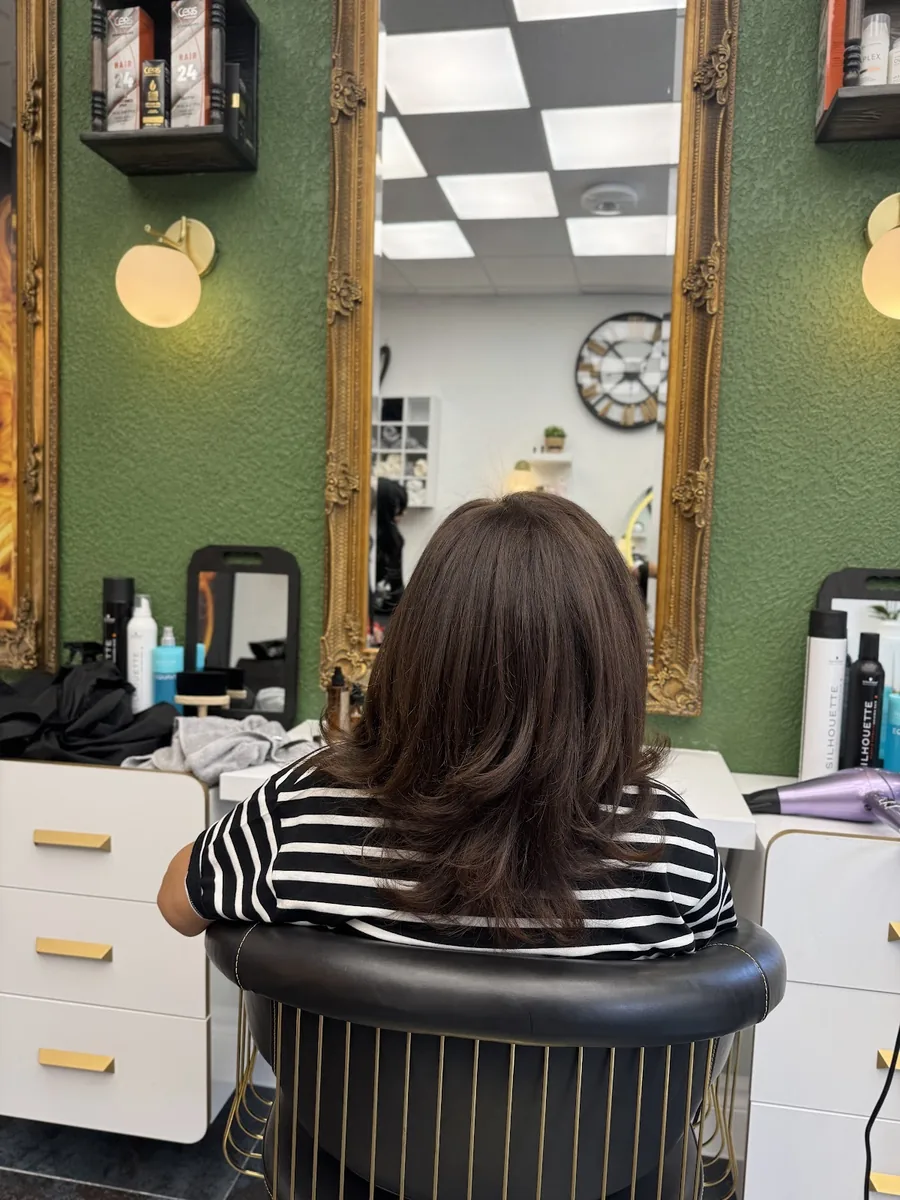 Rear view of a bouncy brown blow-dry with volume through the ends