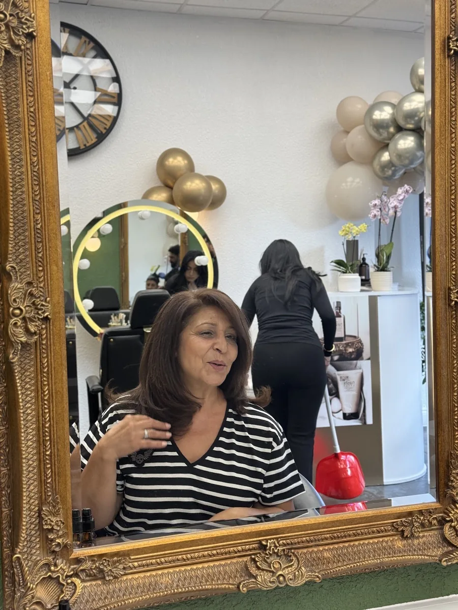 The ornate gold mirror with a finished style reflected in it